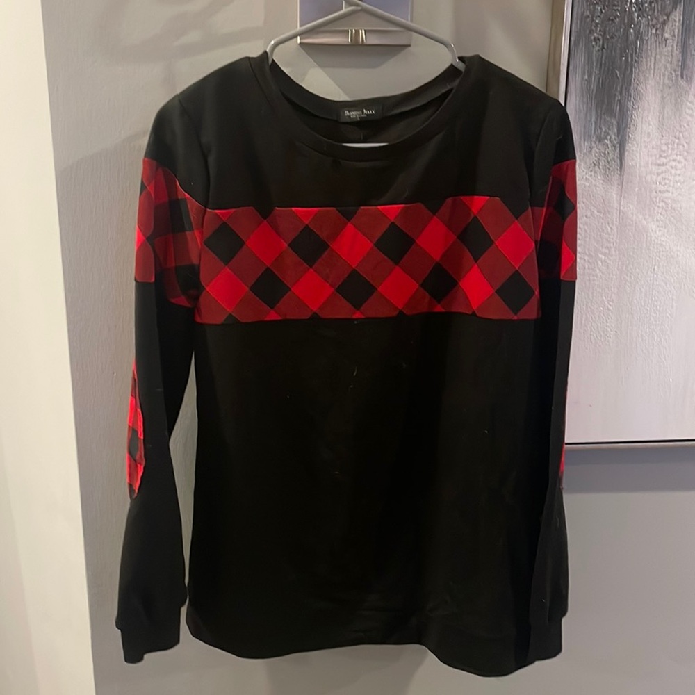 Black sweater with red flannel accents